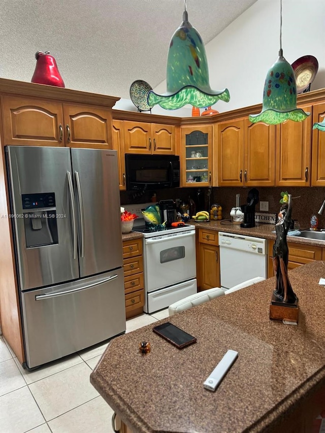 kitchen featuring pendant lighting, white appliances, sink, decorative backsplash, and light tile patterned floors