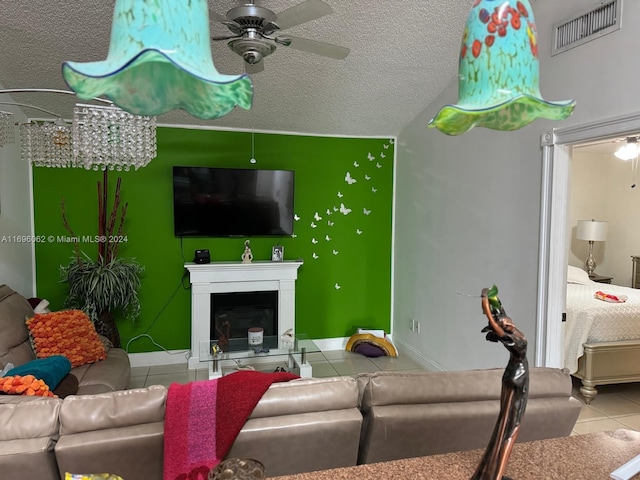 tiled living room featuring a textured ceiling, ceiling fan, and lofted ceiling