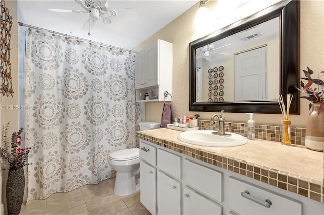 bathroom featuring decorative backsplash, vanity, ceiling fan, tile patterned flooring, and toilet