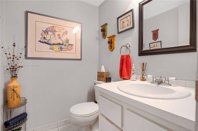 bathroom with tile patterned floors, vanity, and toilet