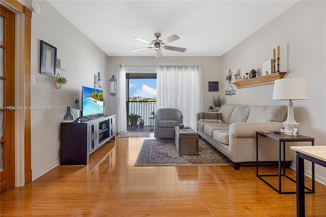 living room featuring ceiling fan and light wood-type flooring