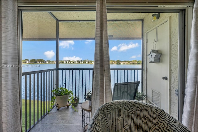 sunroom / solarium with a water view and a healthy amount of sunlight