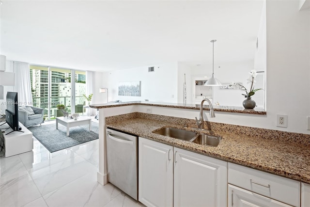 kitchen featuring white cabinets, dishwasher, pendant lighting, and sink