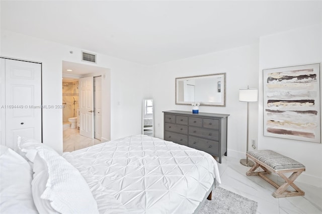 bedroom featuring connected bathroom and a closet