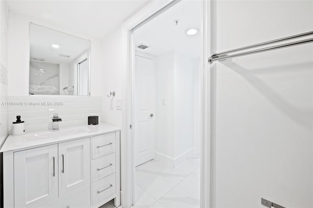 bathroom featuring vanity and backsplash