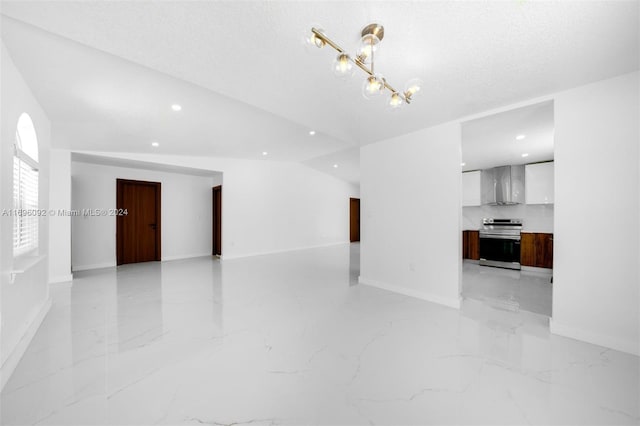 unfurnished living room with a chandelier and a textured ceiling