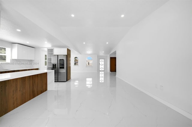 kitchen with white cabinets and stainless steel fridge with ice dispenser