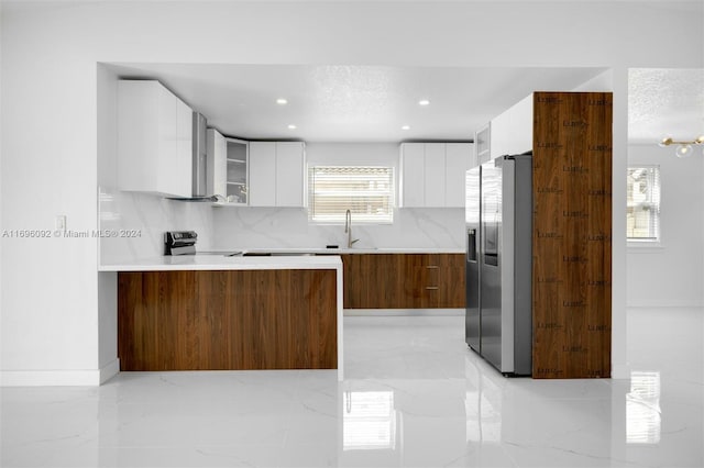 kitchen with decorative backsplash, white cabinetry, a textured ceiling, and appliances with stainless steel finishes