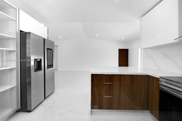 kitchen with stainless steel fridge, light stone counters, white cabinetry, and black electric range