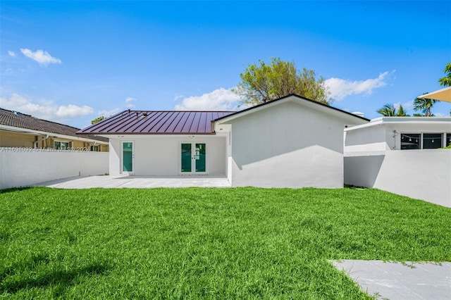 back of house featuring a yard and a patio area