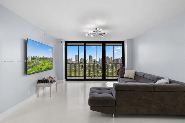 living room with a chandelier and expansive windows