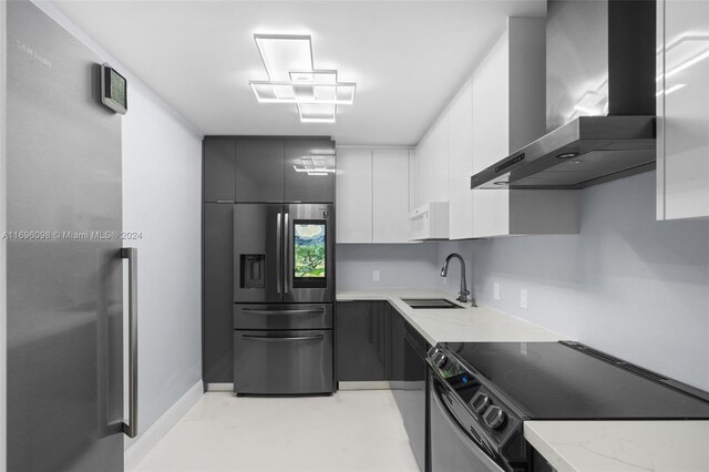 kitchen with white cabinetry, sink, black range oven, wall chimney exhaust hood, and stainless steel refrigerator with ice dispenser