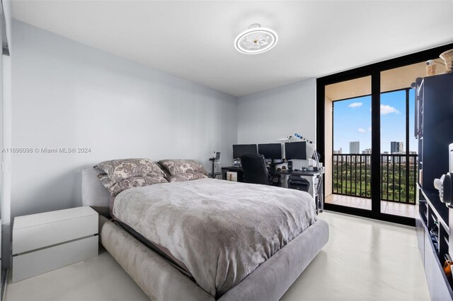 bedroom with expansive windows and access to exterior