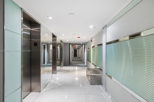corridor featuring light tile patterned floors