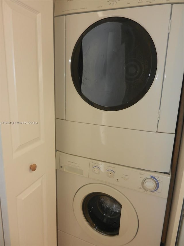 washroom featuring stacked washer and clothes dryer