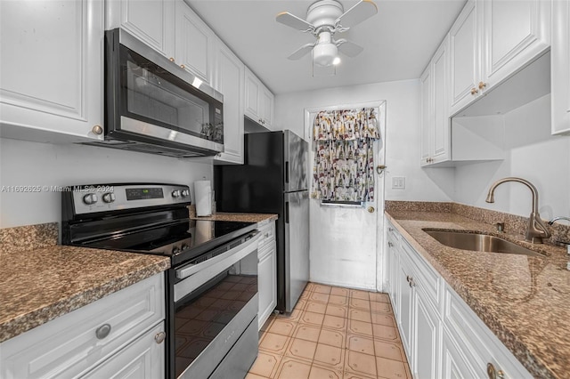 kitchen featuring white cabinets, sink, appliances with stainless steel finishes, and dark stone counters