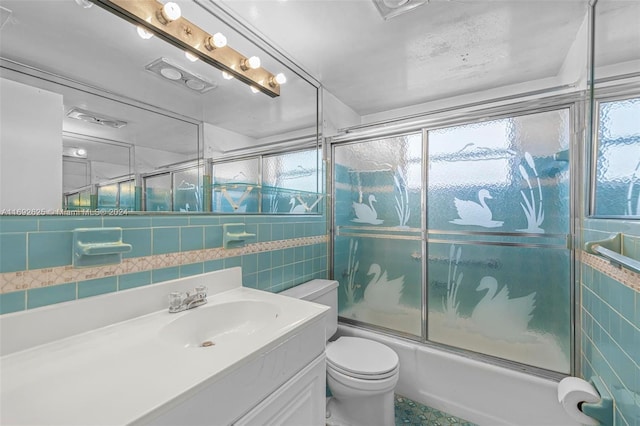 17000 NE 14th Ave Unit 301, North Miami Beach, FL 33162 - full bath featuring tile walls, toilet, vanity, and bath / shower combo with glass door