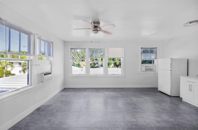 interior space with ceiling fan and cooling unit