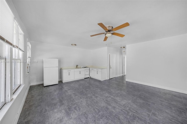 unfurnished living room with ceiling fan and sink