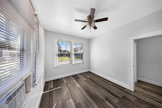 unfurnished bedroom featuring ceiling fan, a closet, and dark hardwood / wood-style floors