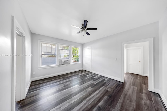 spare room featuring dark hardwood / wood-style flooring, ceiling fan, and cooling unit