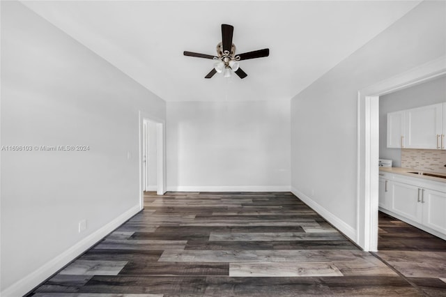 interior space with ceiling fan, sink, and dark hardwood / wood-style floors