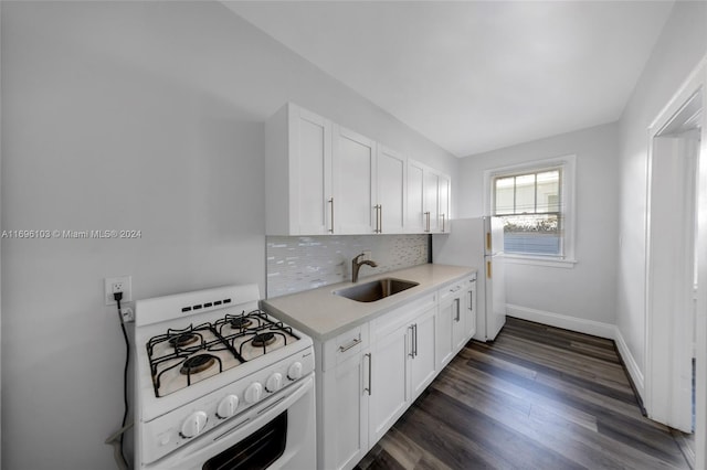 kitchen featuring sink, dark hardwood / wood-style floors, white appliances, decorative backsplash, and white cabinets