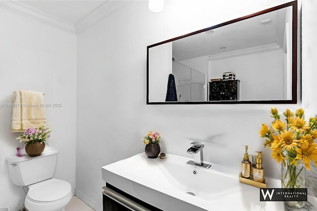 bathroom with vanity, crown molding, and toilet