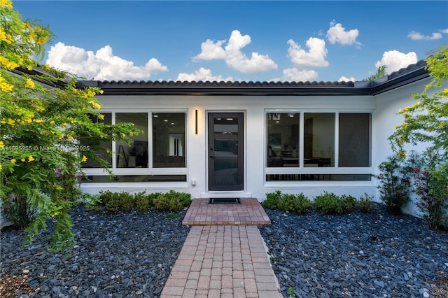 doorway to property with stucco siding