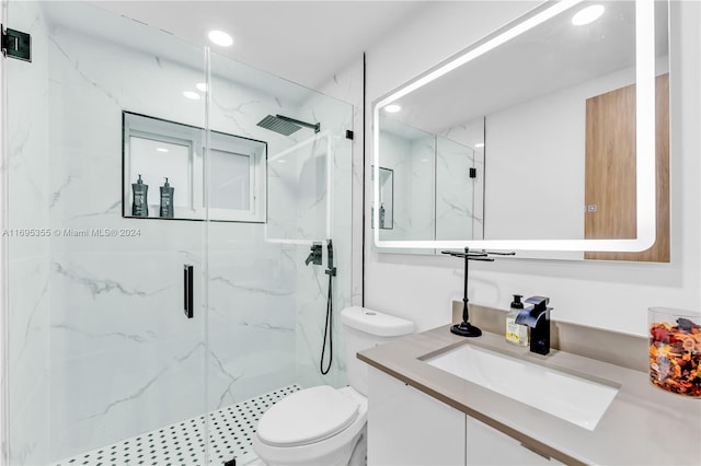 bathroom featuring vanity, toilet, and an enclosed shower