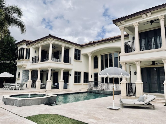 view of pool featuring ceiling fan, a patio, and an in ground hot tub