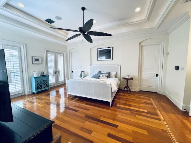 bedroom featuring french doors, dark hardwood / wood-style floors, ceiling fan, access to exterior, and a tray ceiling