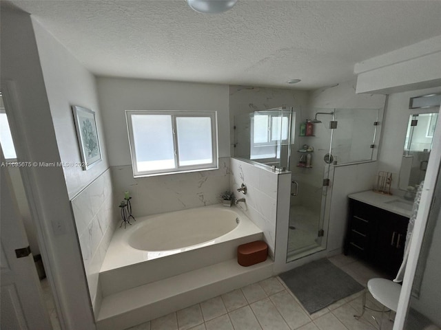 bathroom featuring vanity, a textured ceiling, separate shower and tub, and tile walls