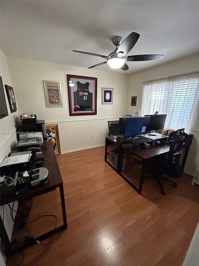 office featuring hardwood / wood-style flooring, ceiling fan, and a textured ceiling