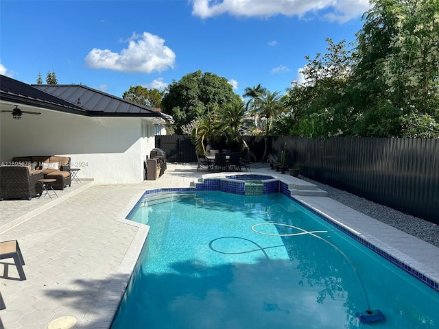 view of pool with a patio area and an in ground hot tub