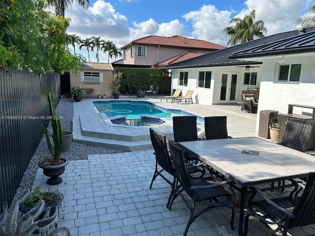 view of swimming pool featuring an in ground hot tub, a patio, and ceiling fan