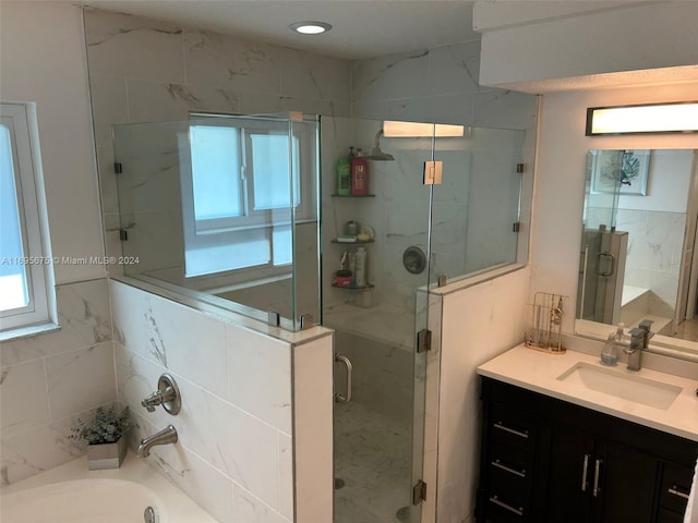 bathroom featuring vanity and separate shower and tub