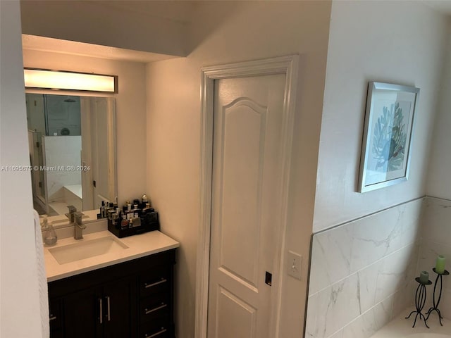 bathroom with vanity and tile walls