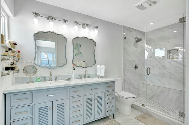 bathroom with a sink, visible vents, a marble finish shower, and marble finish floor