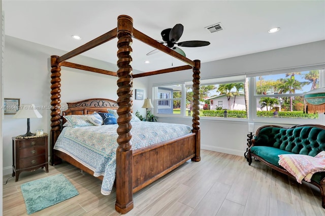 bedroom featuring light wood finished floors, visible vents, recessed lighting, and baseboards