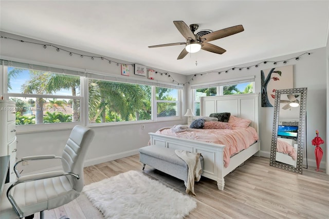 bedroom with baseboards, light wood-style floors, and ceiling fan