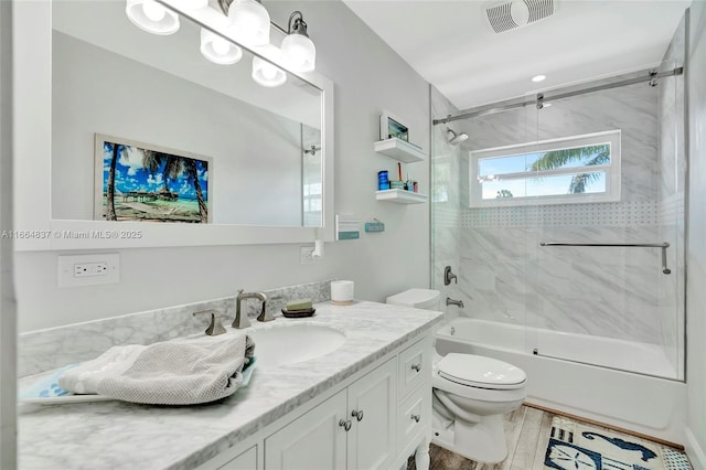 full bathroom with visible vents, toilet, shower / bathtub combination, wood finished floors, and vanity