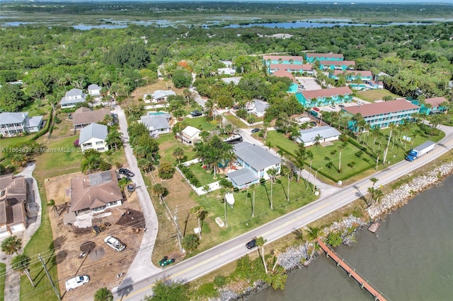 birds eye view of property featuring a view of trees and a water view