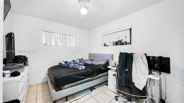 bedroom with ceiling fan and light tile patterned floors