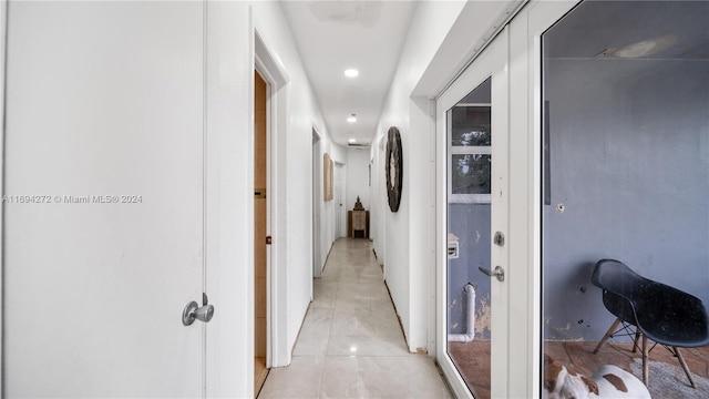 hall featuring light tile patterned floors