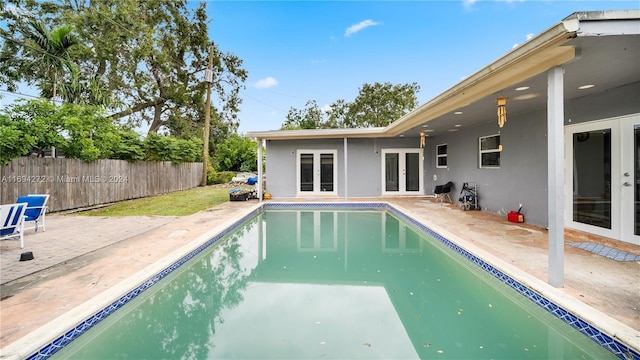 view of pool featuring a patio area and french doors