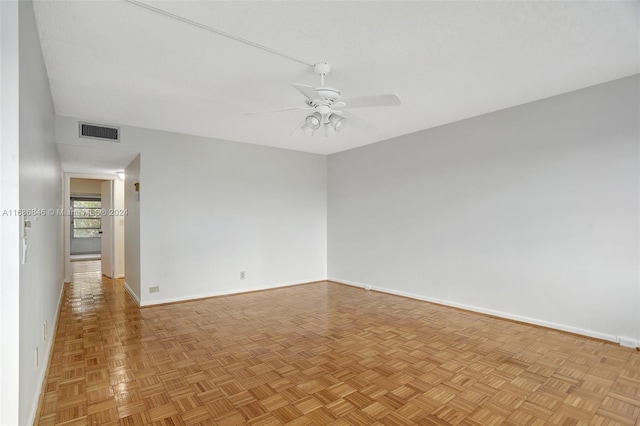 spare room with light parquet flooring and ceiling fan