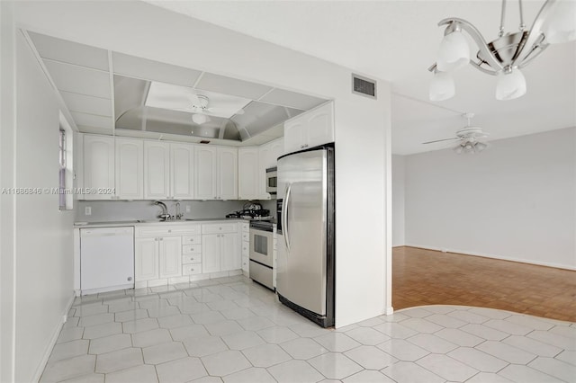 kitchen featuring ceiling fan, sink, white cabinetry, and stainless steel appliances