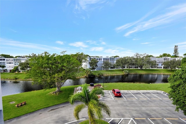 view of property's community featuring a water view and a yard