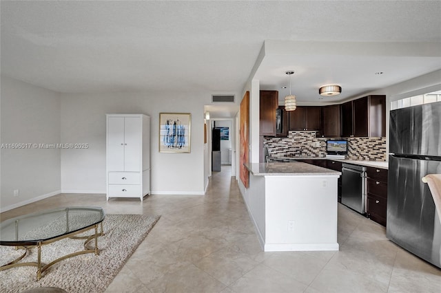 kitchen with dark brown cabinetry, tasteful backsplash, visible vents, stainless steel appliances, and baseboards